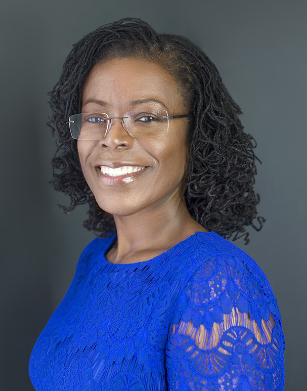 Professional headshot of a smiling business advisor in a blue top
